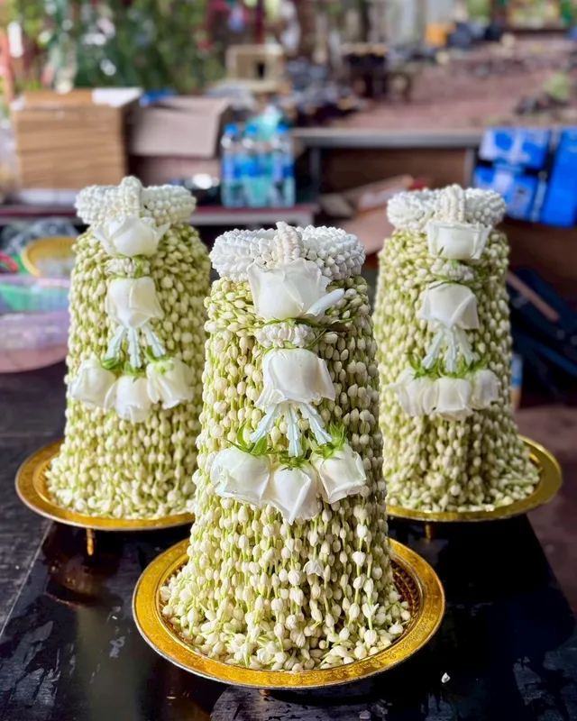Golden trays of fresh jasmine garlands for vow offerings at Wat Phra That Doi Kham, Chiang Mai