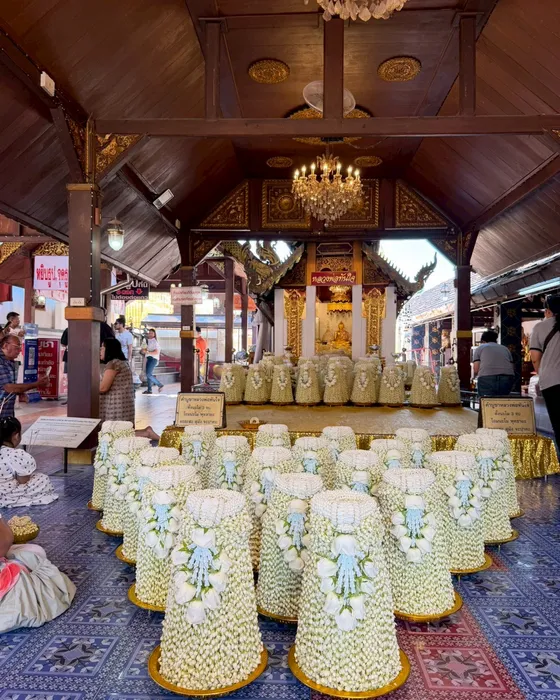 Hundreds of jasmine garland trays offered to Luang Pho Tan Jai inside Wat Phra That Doi Kham